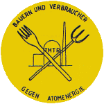Logo of farmers and consumers against atomic energy - a pitchfork and fork crossed in front of the THTR 300 high temperature reactor Hamm-Uentrop